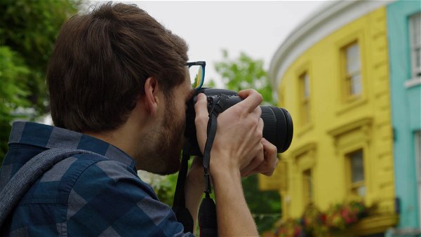 Man taking photograph colourful house.mp4